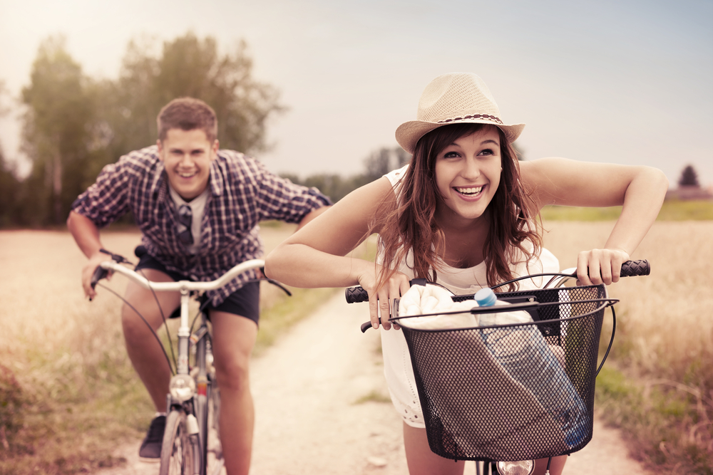 man and woman biking